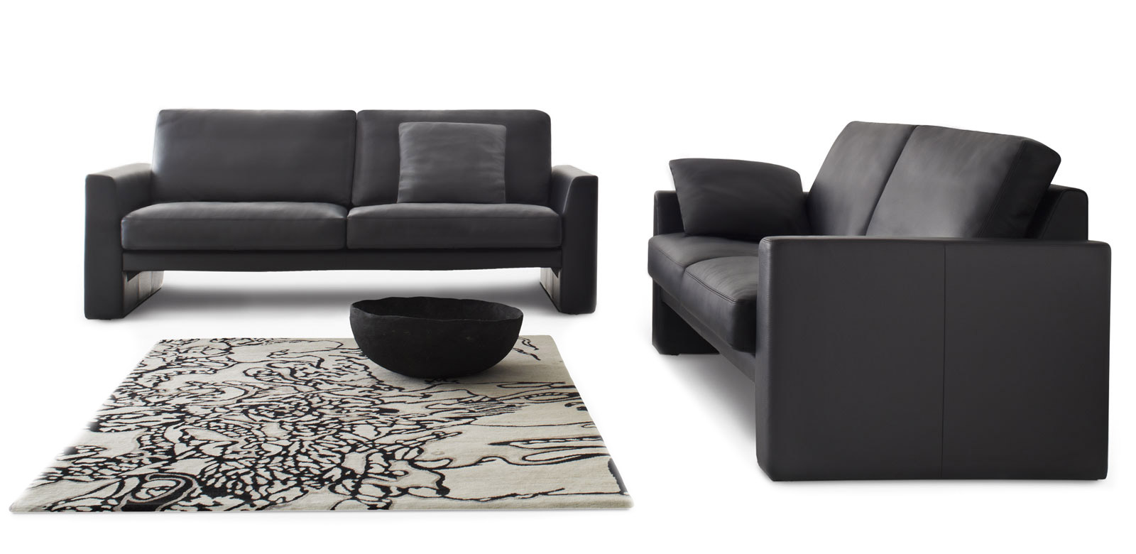 CL100 sofa group in black leather with matching cushions.