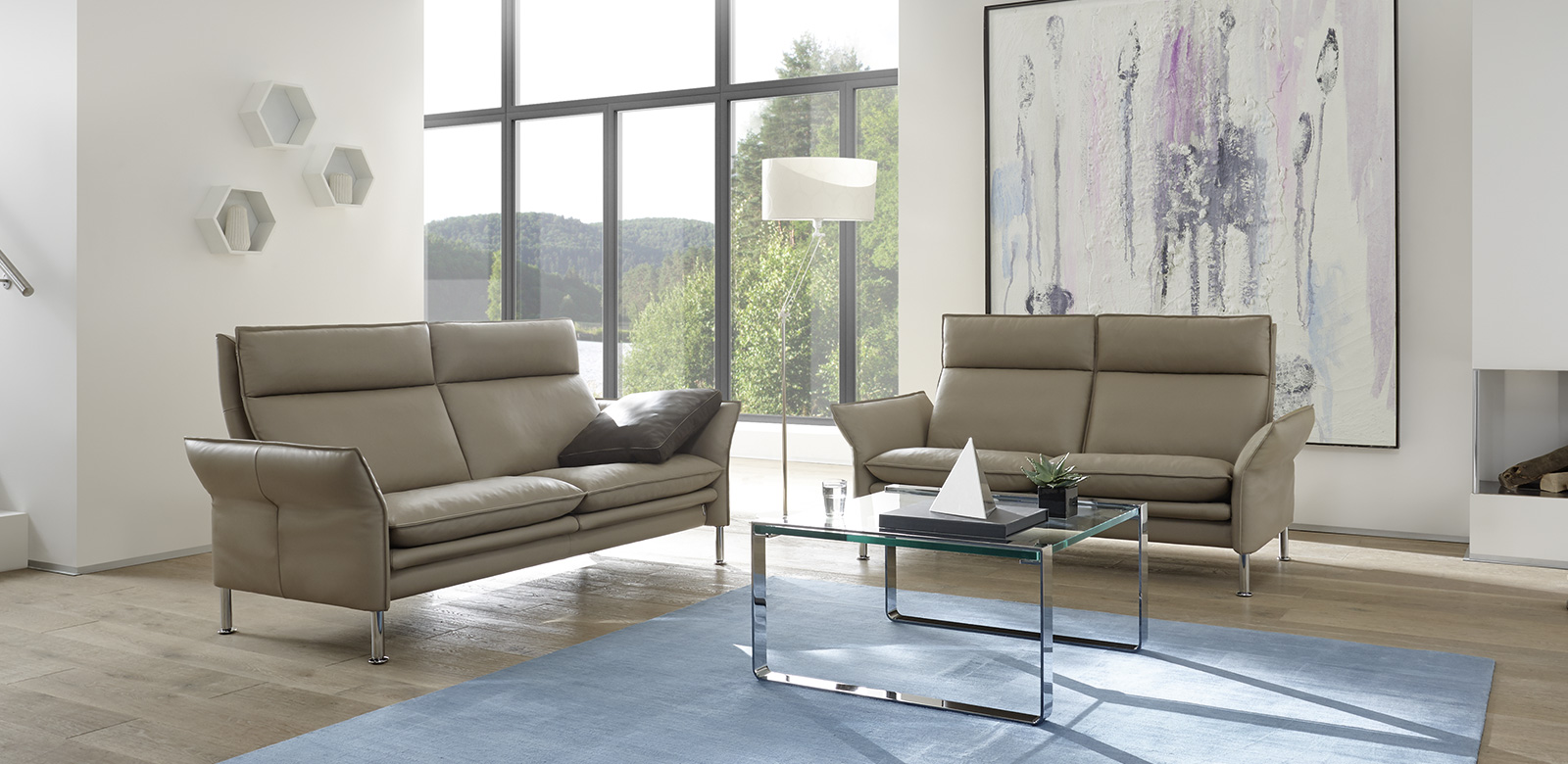 Porto seating group consisting of two sofas in beige leather in a modern villa by the lake.
