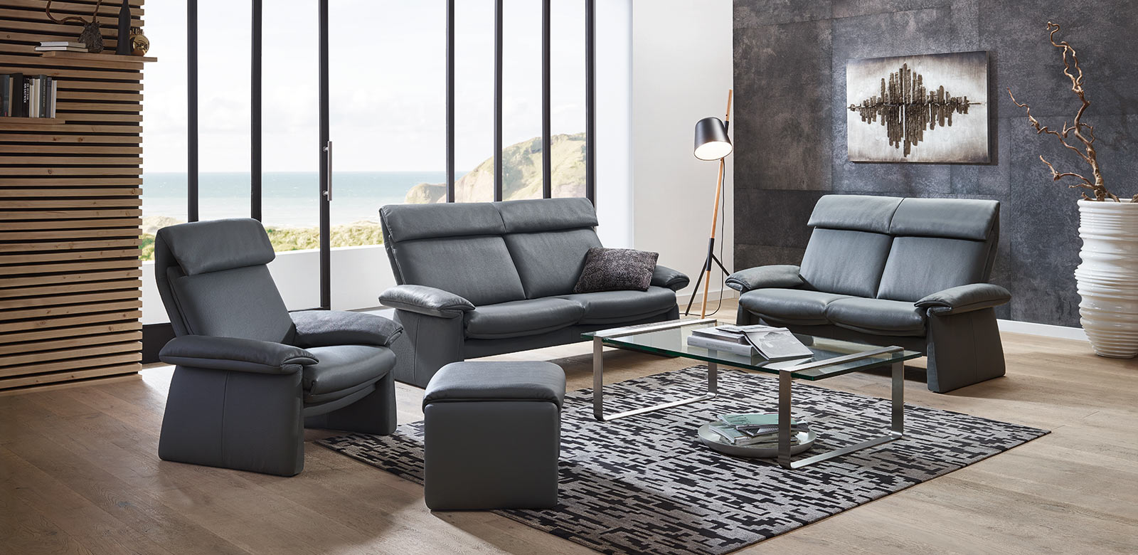 The flat shape and the fine, straight lines are proof of the design aspirations of this sofa with relax function, which is more up-to-date than ever. Combination of two sofas and armchair with stool in modern beach villa.