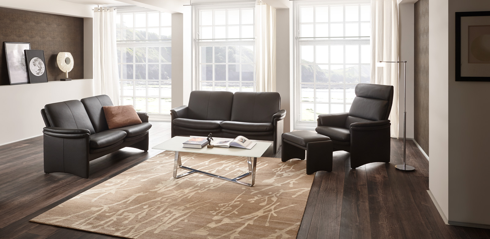 The high-quality City sofa convinces with its filigree details: the slender cheeks, the double lines of the seat, the elegant armrest bent at 90 degrees and the fine centre seam on the backrest and side panel. The armchair on the left has an additional neckrest.